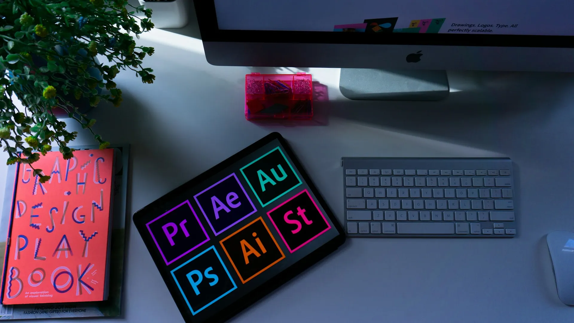 Design tools and a brand playbook on a desk